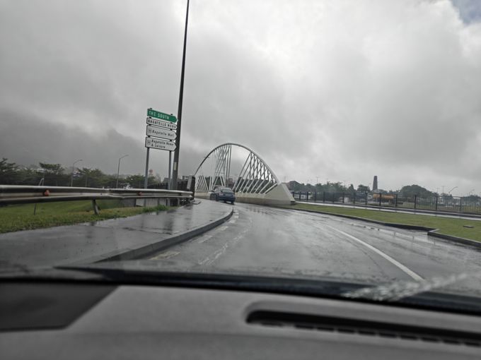 A blurry shot of a bridge with a metal arch over it