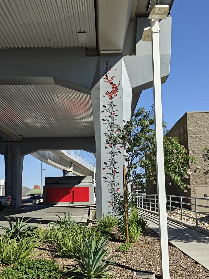 A pillar of a rail bridge with a painted carving