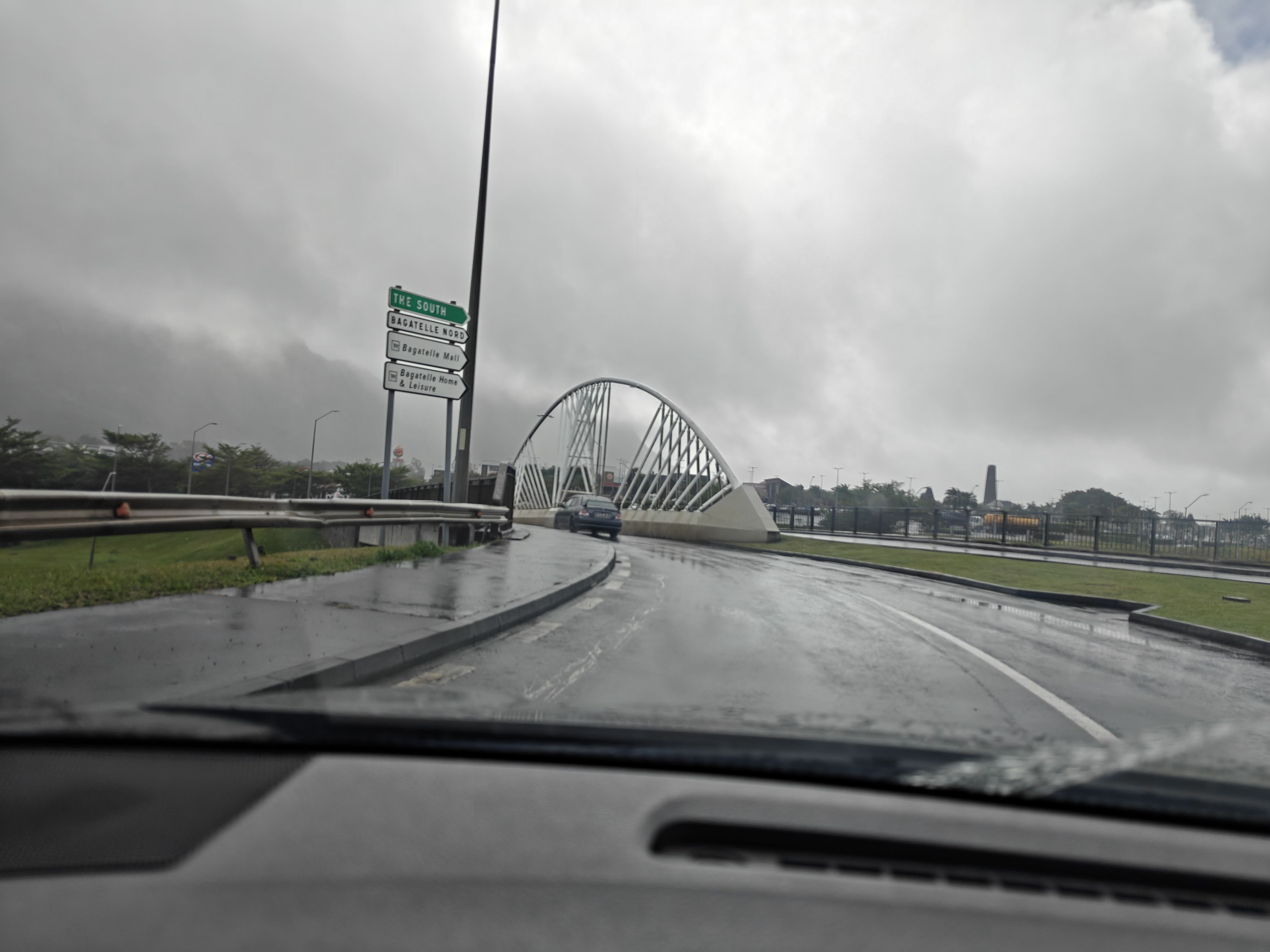 A blurry shot of a bridge with a metal arch over it