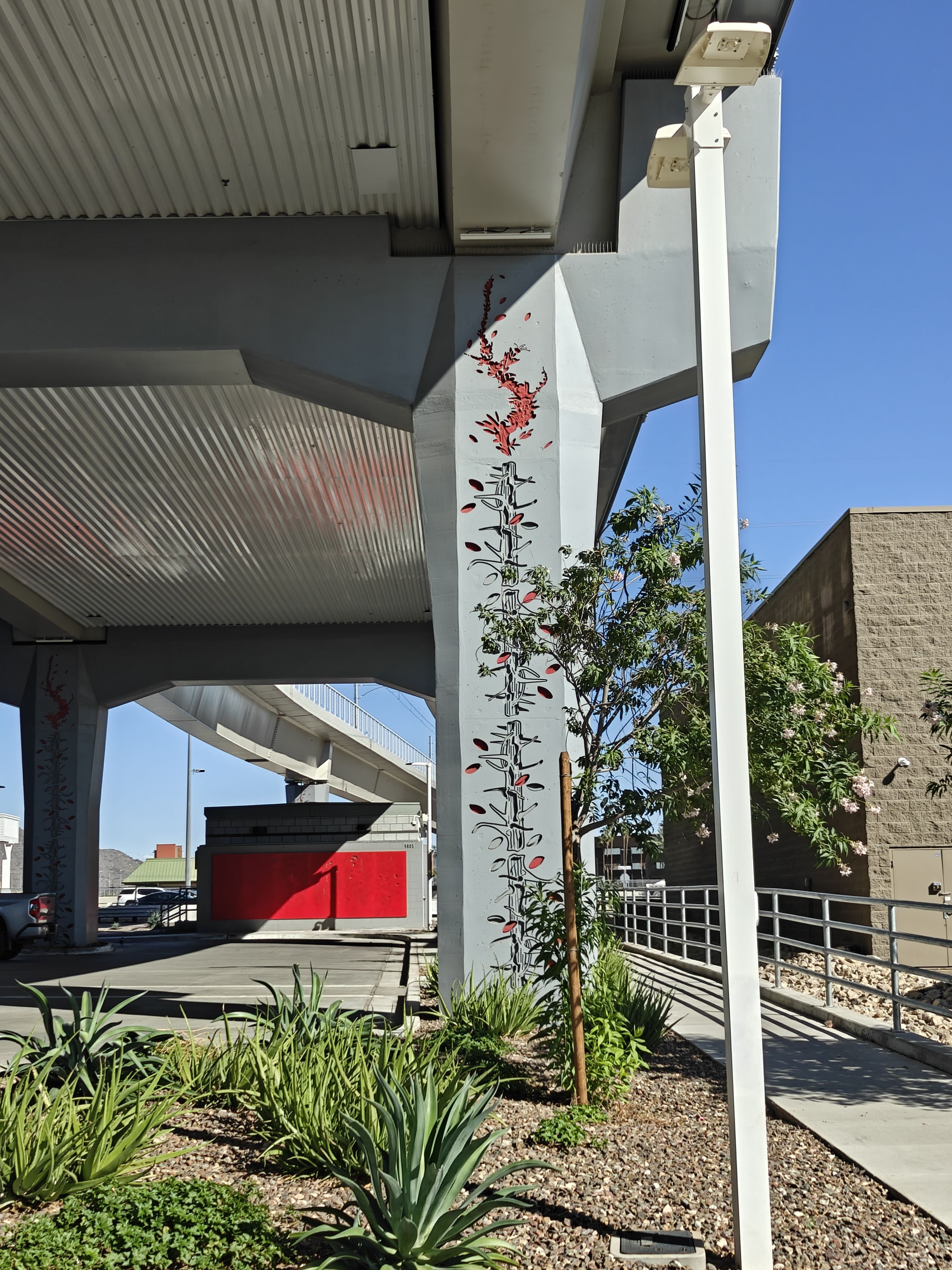 A pillar of a rail bridge with a painted carving